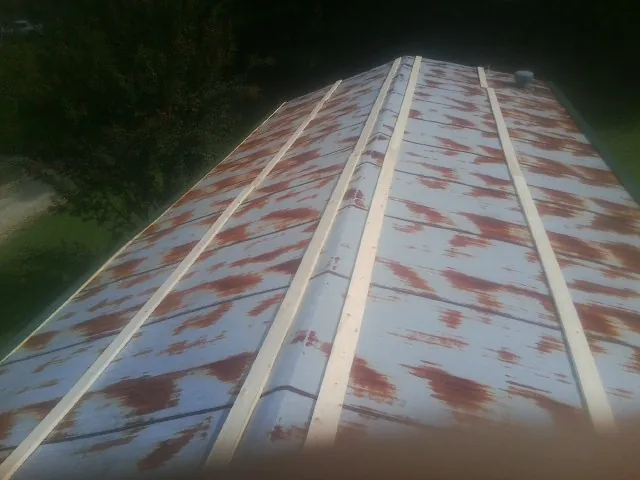 Rusted metal roof panels with new wood purlins before replacement — Storm Damage Roof Repair in Scotrun by Roofing Brothers