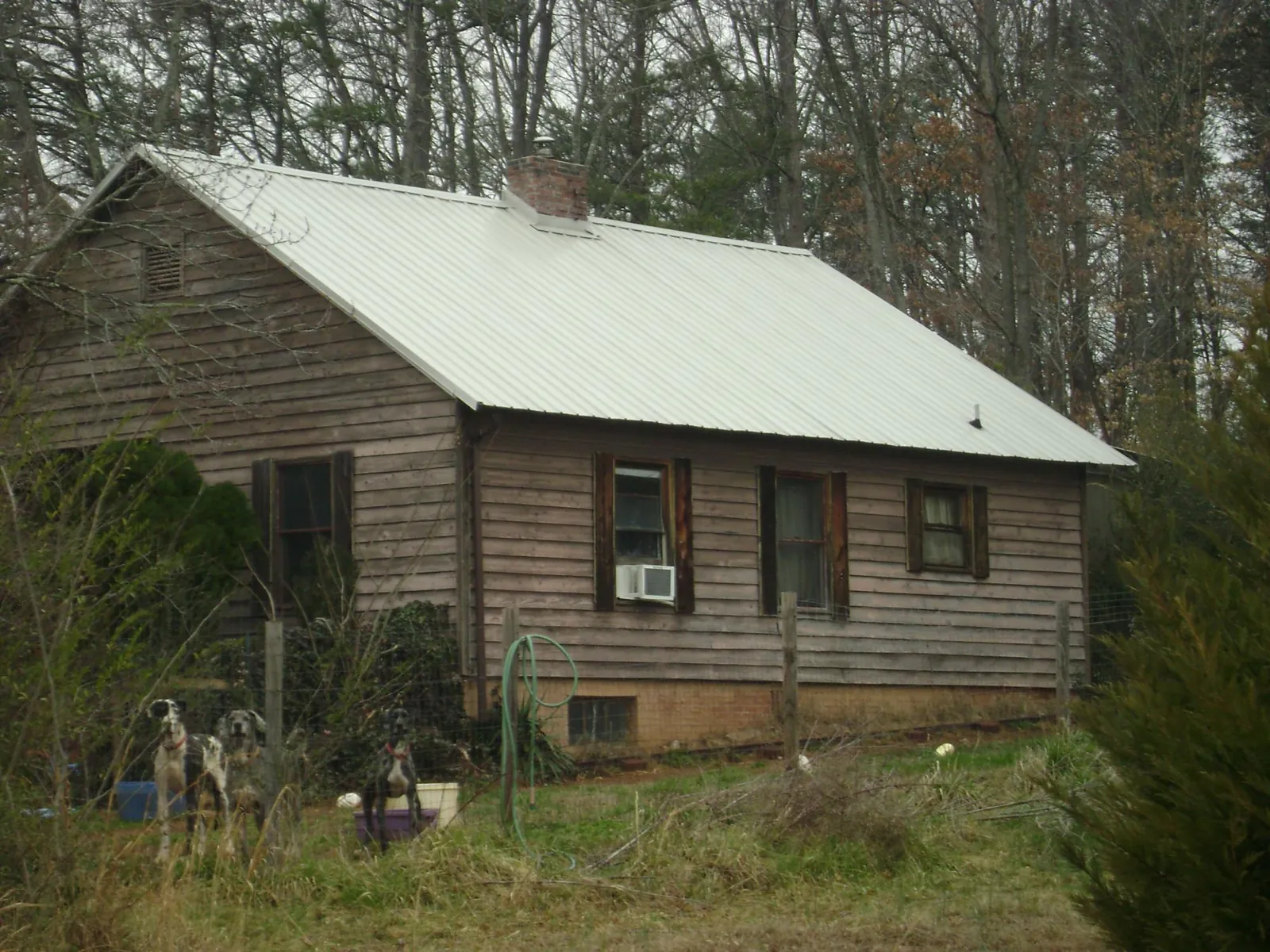 White metal roof on an old wood sided farmhouse, from a Asphalt Shingle Roof Repair job in Scotrun